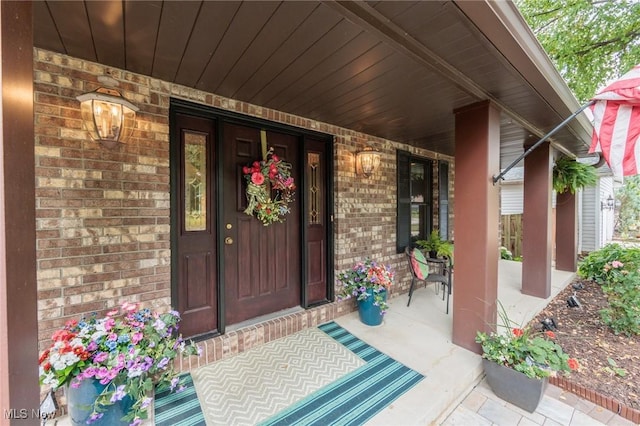 6252 Pebblebrook Ln, North Olmsted, OH 44070 - doorway to property featuring covered porch and brick siding