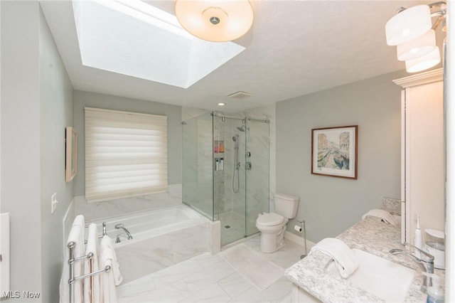 6252 Pebblebrook Ln, North Olmsted, OH 44070 - full bath featuring a garden tub, marble look tile flooring, a marble finish shower, vanity, and a skylight