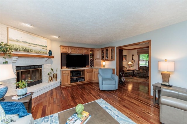 6252 Pebblebrook Ln, North Olmsted, OH 44070 - living room with dark wood-type flooring, a brick fireplace, and a textured ceiling
