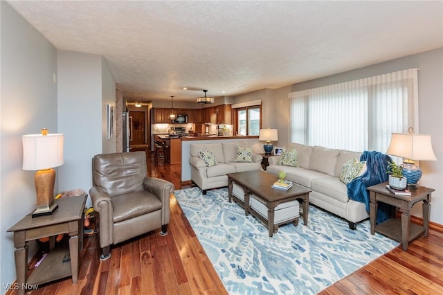6252 Pebblebrook Ln, North Olmsted, OH 44070 - living room featuring wood finished floors and a textured ceiling
