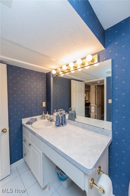 6252 Pebblebrook Ln, North Olmsted, OH 44070 - bathroom with wallpapered walls, vanity, tile patterned floors, and a textured ceiling