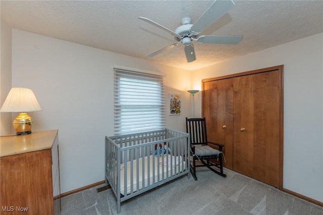 6252 Pebblebrook Ln, North Olmsted, OH 44070 - bedroom featuring carpet flooring, a closet, ceiling fan, a nursery area, and a textured ceiling