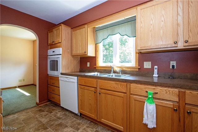 2456 Batdorf Rd, Wooster, OH 44691 - kitchen featuring white appliances, arched walkways, dark countertops, and dark carpet