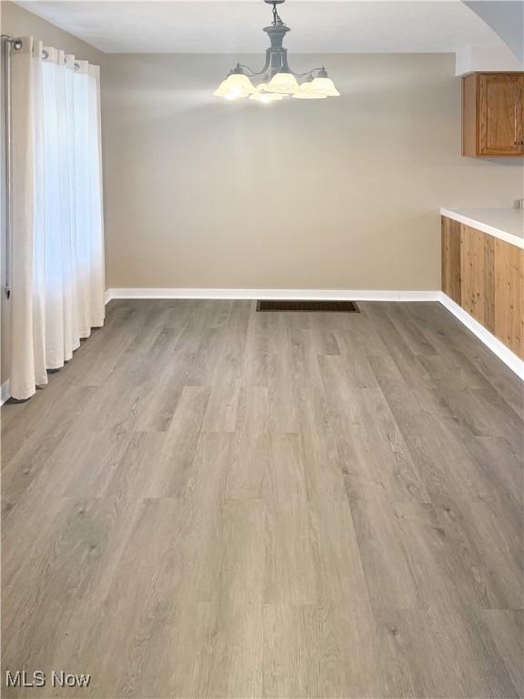 1209 Courtland Rd, Weirton, WV 26062 - unfurnished dining area featuring wood finished floors and a chandelier