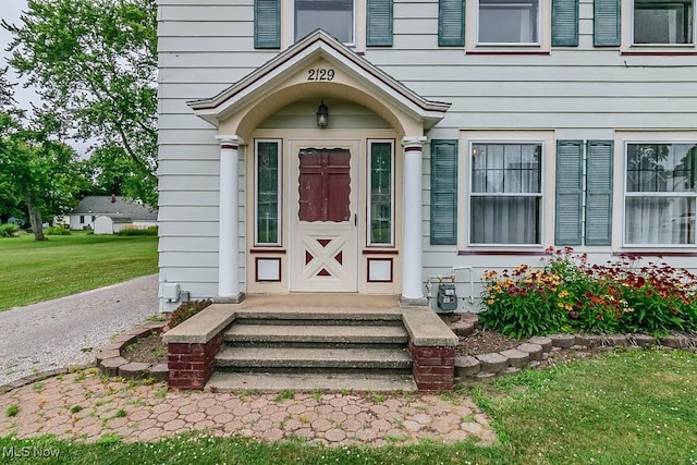 2129 E 41st St, Ashtabula, OH 44004 - view of exterior entry with a yard