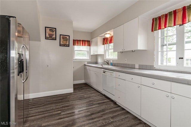 2129 E 41st St, Ashtabula, OH 44004 - kitchen featuring stainless steel refrigerator with ice dispenser, dishwasher, tile countertops, dark wood-type flooring, and white cabinets
