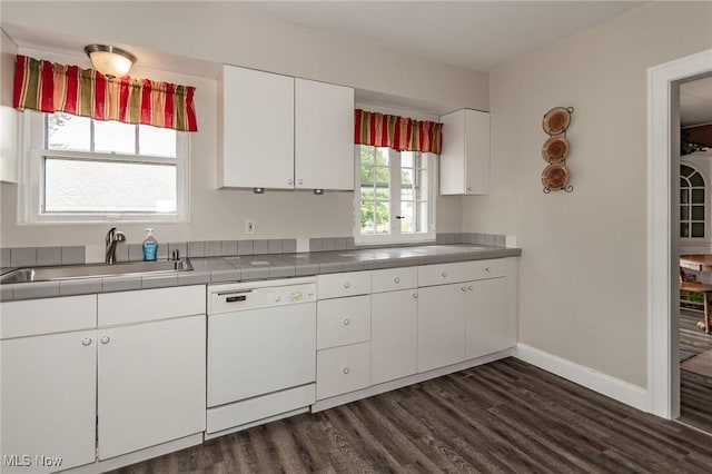 2129 E 41st St, Ashtabula, OH 44004 - kitchen with dishwasher, tile countertops, white cabinetry, and dark wood finished floors