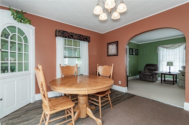 2129 E 41st St, Ashtabula, OH 44004 - dining area featuring arched walkways, a chandelier, ornamental molding, wood finished floors, and carpet