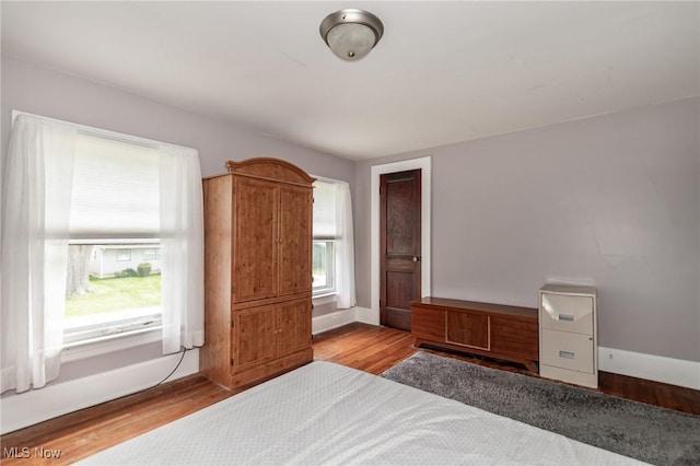 2129 E 41st St, Ashtabula, OH 44004 - unfurnished bedroom featuring wood finished floors and baseboards