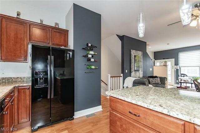 12591 Larchmere Blvd Unit W-6, Cleveland, OH 44120 - kitchen with black fridge with ice dispenser, light wood-style floors, ceiling fan, open floor plan, and light stone countertops