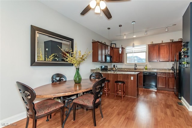 12591 Larchmere Blvd Unit W-6, Cleveland, OH 44120 - dining area with light wood finished floors, a ceiling fan, and rail lighting