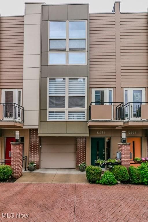 12591 Larchmere Blvd Unit W-6, Cleveland, OH 44120 - view of building exterior featuring decorative driveway and an attached garage
