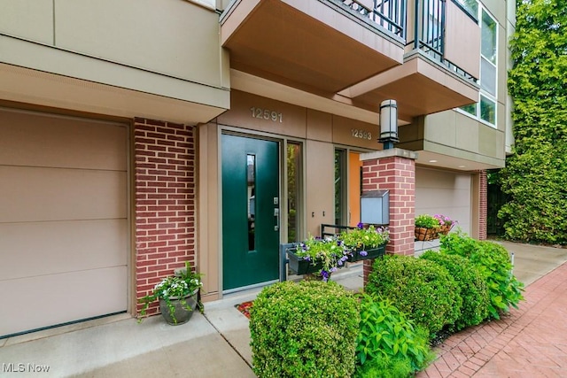 12591 Larchmere Blvd Unit W-6, Cleveland, OH 44120 - doorway to property with brick siding, an attached garage, and a balcony