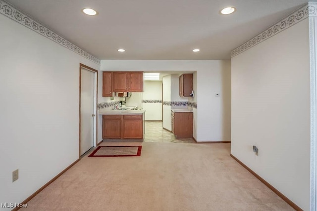 4039 Tannybrooke Ln NW Unit C, Canton, OH 44718 - kitchen with light countertops, light carpet, recessed lighting, and brown cabinetry