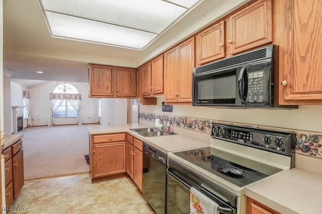 4039 Tannybrooke Ln NW Unit C, Canton, OH 44718 - kitchen with black appliances, a peninsula, light countertops, and light carpet
