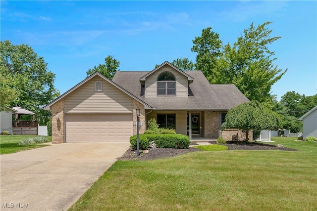 230 Clingan Rd, Struthers, OH 44471 - view of front of house with brick siding, an attached garage, driveway, and a front lawn