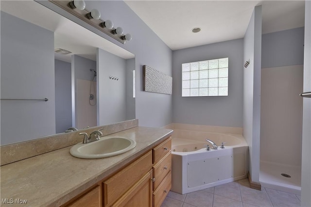 230 Clingan Rd, Struthers, OH 44471 - bathroom with a tub with jets, vanity, a walk in shower, and tile patterned flooring
