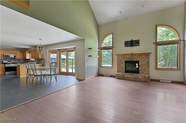 230 Clingan Rd, Struthers, OH 44471 - living area with healthy amount of natural light, a high ceiling, dark wood finished floors, and a fireplace