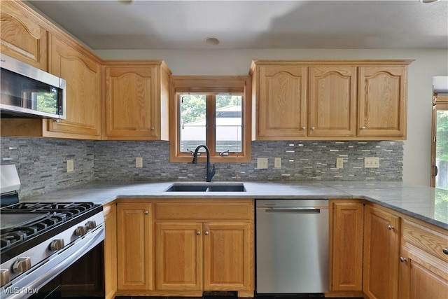 230 Clingan Rd, Struthers, OH 44471 - kitchen featuring appliances with stainless steel finishes, healthy amount of natural light, backsplash, and light brown cabinetry