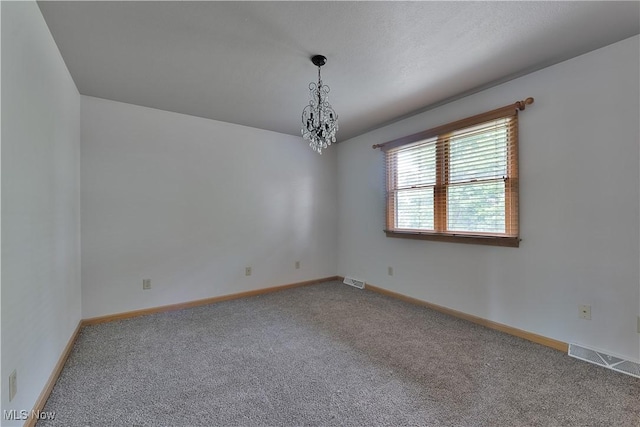 230 Clingan Rd, Struthers, OH 44471 - carpeted spare room with a chandelier and baseboards
