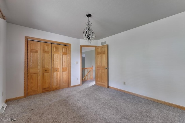 230 Clingan Rd, Struthers, OH 44471 - unfurnished bedroom featuring carpet and a chandelier