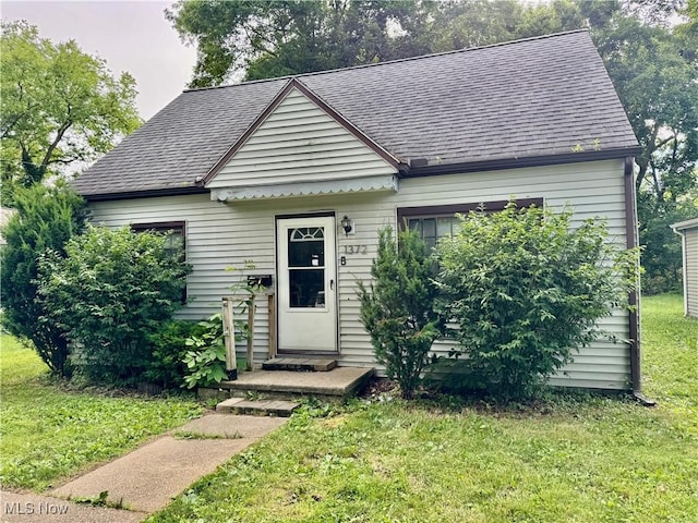 1372 Frederick Blvd, Akron, OH 44320 - view of front facade with a front lawn and a shingled roof