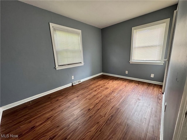 1372 Frederick Blvd, Akron, OH 44320 - empty room with dark wood-type flooring and healthy amount of natural light