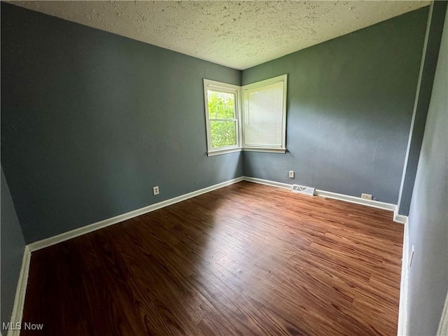1372 Frederick Blvd, Akron, OH 44320 - spare room with wood finished floors and a textured ceiling
