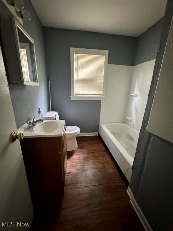 1372 Frederick Blvd, Akron, OH 44320 - bathroom with vanity, a tub to relax in, and wood finished floors