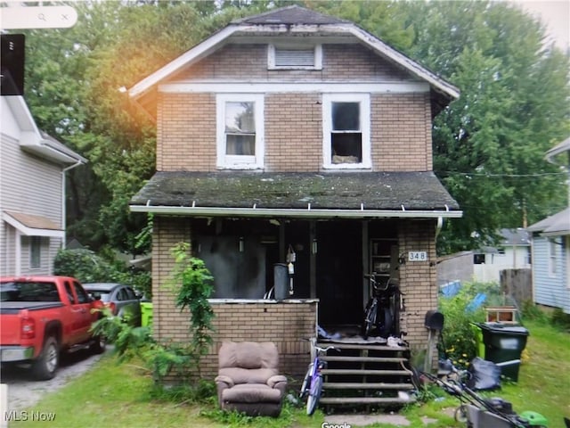 348 Garfield St, Newton Falls, OH 44444 - view of front facade with brick siding and a porch