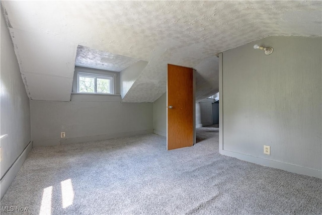 312 28th St SW, Canton, OH 44706 - bonus room featuring vaulted ceiling, a textured ceiling, and carpet