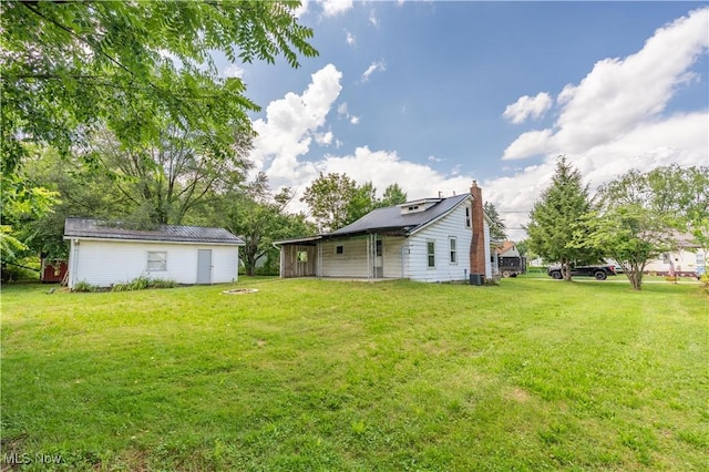 312 28th St SW, Canton, OH 44706 - rear view of property featuring a chimney and a yard