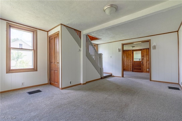 312 28th St SW, Canton, OH 44706 - unfurnished room with carpet, stairway, a textured ceiling, and beamed ceiling