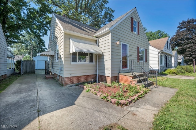 24850 Shoreview Ave, Euclid, OH 44123 - view of front of property featuring concrete driveway, a shingled roof, and a detached garage