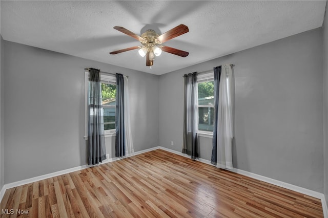 24850 Shoreview Ave, Euclid, OH 44123 - empty room featuring wood finished floors, ceiling fan, and a textured ceiling