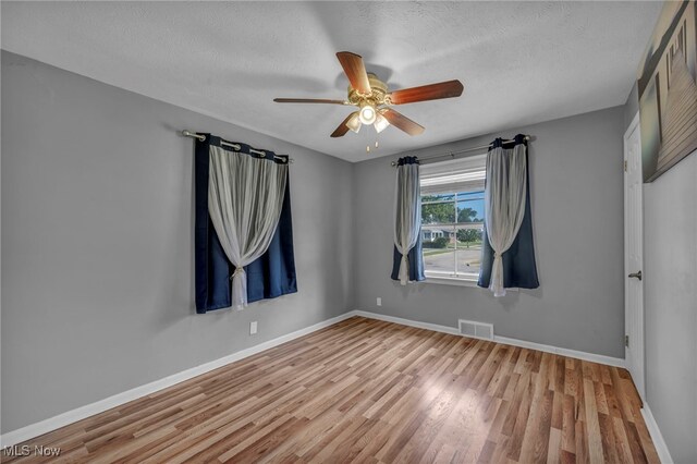 24850 Shoreview Ave, Euclid, OH 44123 - empty room featuring wood finished floors, ceiling fan, and a textured ceiling