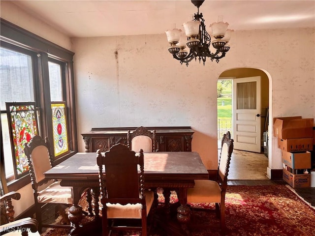 8 E Main St, New Concord, OH 43762 - dining area with a chandelier, arched walkways, and wallpapered walls