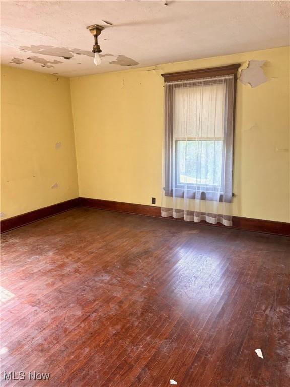 8 E Main St, New Concord, OH 43762 - unfurnished room with wood-type flooring and a ceiling fan