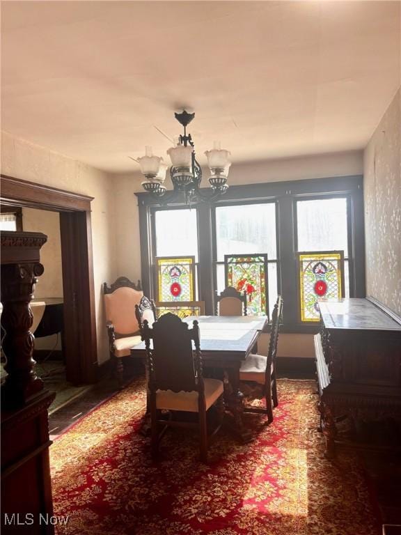 8 E Main St, New Concord, OH 43762 - dining space with healthy amount of natural light, wood finished floors, and a chandelier