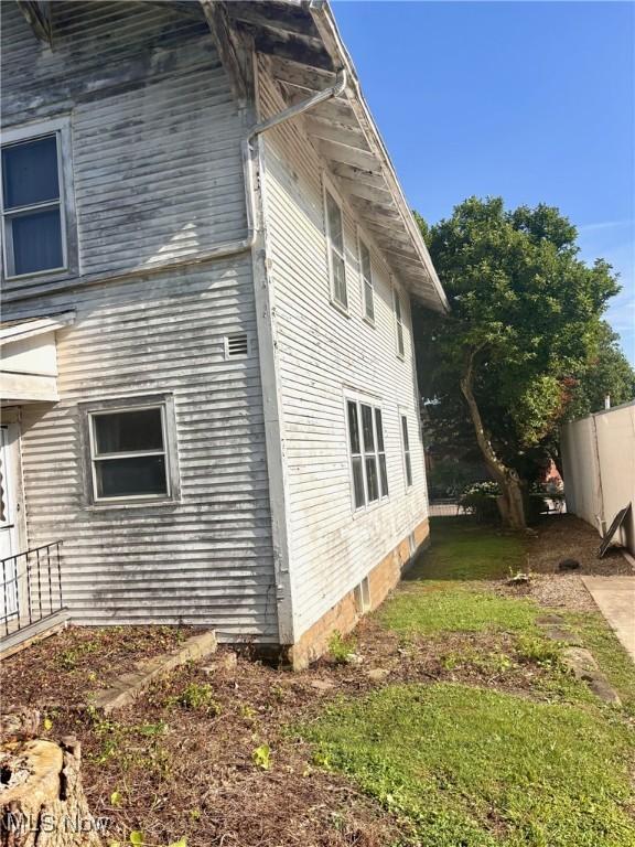 8 E Main St, New Concord, OH 43762 - view of side of home with a lawn
