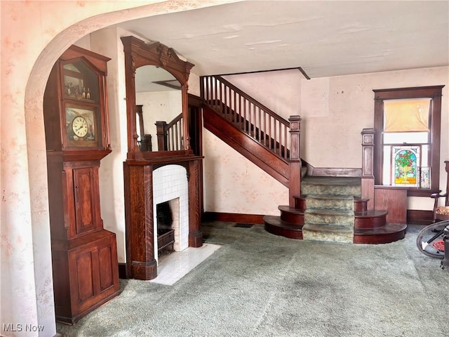 8 E Main St, New Concord, OH 43762 - stairs featuring carpet, arched walkways, and a fireplace with flush hearth