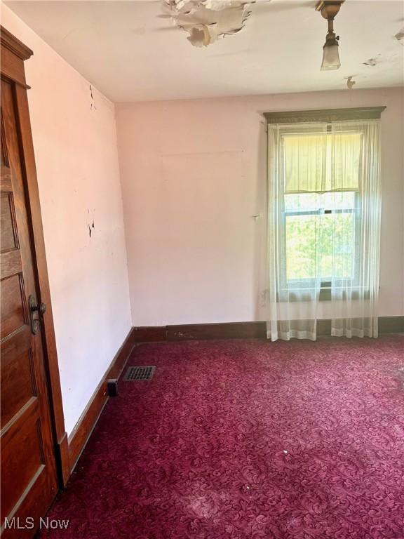 8 E Main St, New Concord, OH 43762 - carpeted empty room featuring baseboards