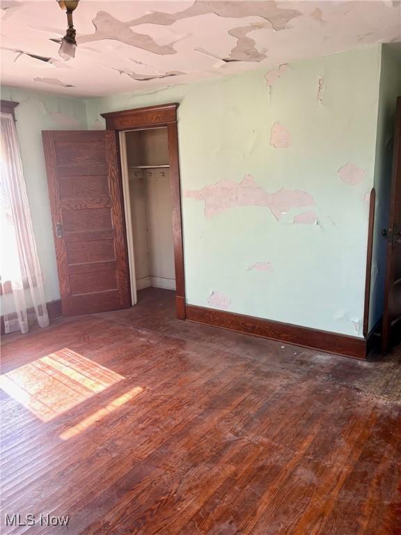 8 E Main St, New Concord, OH 43762 - unfurnished bedroom with hardwood / wood-style floors and a closet