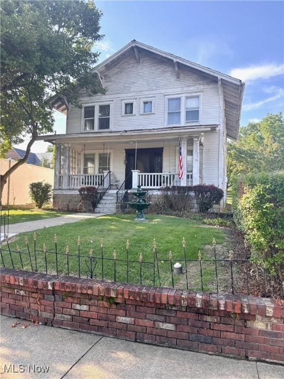 8 E Main St, New Concord, OH 43762 - view of front of house featuring covered porch and a fenced front yard