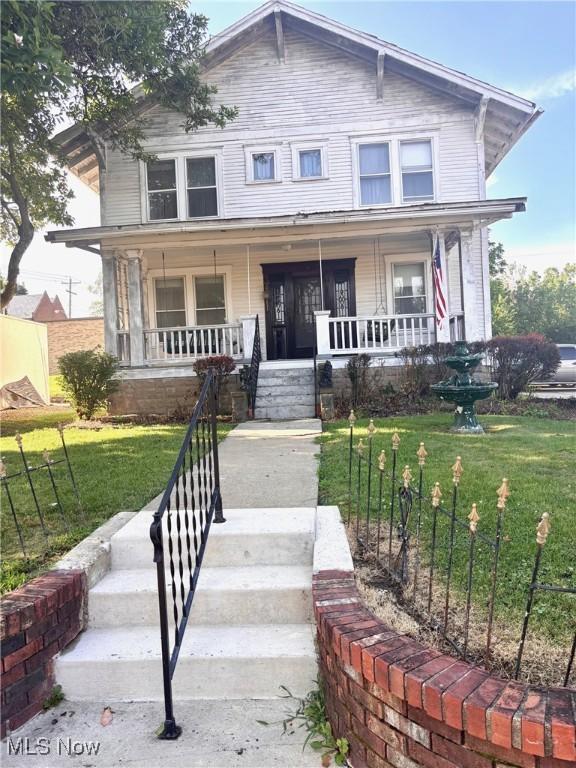 8 E Main St, New Concord, OH 43762 - view of front of property featuring covered porch and a front lawn