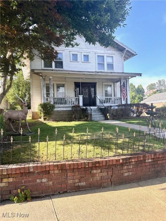 8 E Main St, New Concord, OH 43762 - view of front facade with a porch and a fenced front yard