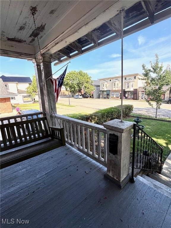 8 E Main St, New Concord, OH 43762 - wooden porch with a residential view and a lawn