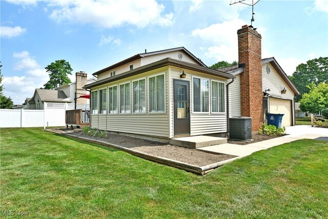 8518 Four Seasons Trl, Poland, OH 44514 - rear view of house featuring a garage and a chimney