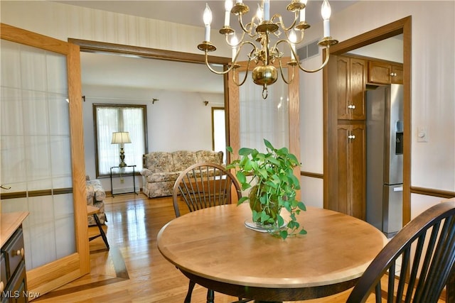 8518 Four Seasons Trl, Poland, OH 44514 - dining space featuring light wood-style flooring and a chandelier