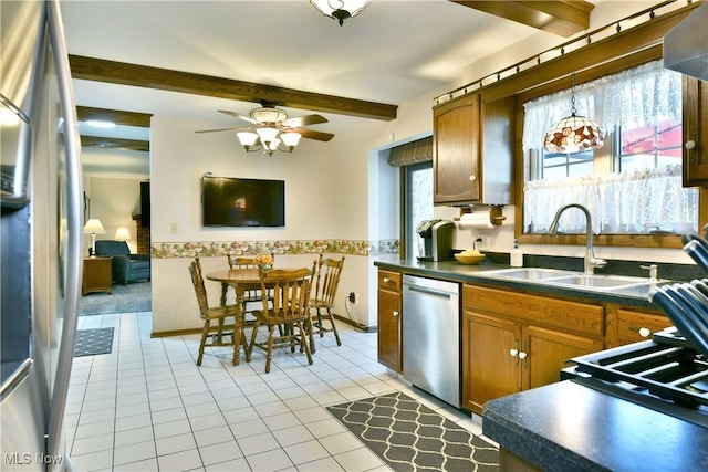 8518 Four Seasons Trl, Poland, OH 44514 - kitchen featuring stainless steel appliances, dark countertops, beamed ceiling, light tile patterned floors, and ceiling fan